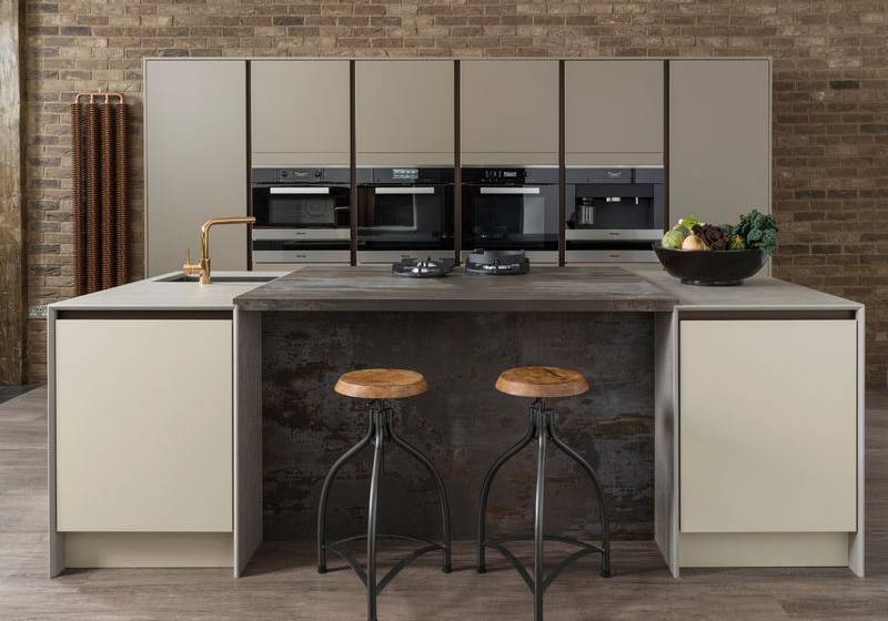 Linear fitted kitchen in Avant Clay and Stone with bar stools